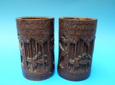 A pair of Chinese bamboo brush pots each carved with figures among trees, 15.