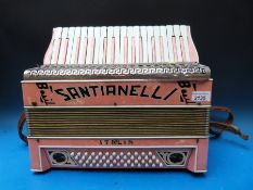 A 1930s Santianelli Italian 48 bass piano accordion in attractive pale pink pearloid case (no carry