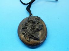 A Victorian boxwood locket with carved flower to the front opening to reveal carved sections