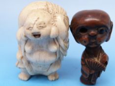 A Japanese ivory netsuke of Hotei together with another boxwood netsuke