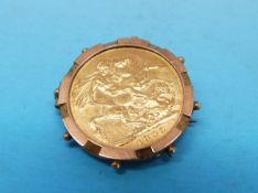 A 1909 Edwardian gold full sovereign in a yellow metal mount marked 9ct