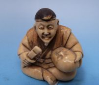 A Japanese ivory netsuke of a mask maker