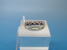 An 18ct gold ring set with five diamonds in a platinum twist setting (size N)