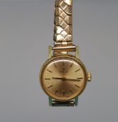 An Omega ladies' wristwatch with black hands and gold plated markers on gold face with expanding