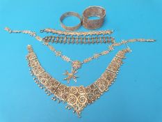 A collection of white metal filigree jewellery including two necklaces,