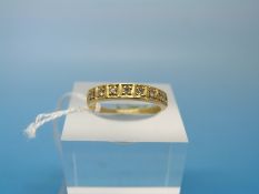 An 18ct gold ring set with eight diamonds in a square setting (size M)