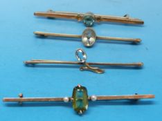 Three yellow metal brooches marked 9ct set with aquamarines and yellow metal brooch set with a