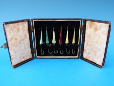 A cased set of six hallmarked silver and guilloché enamel cocktail sticks in the form of umbrellas,