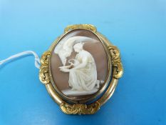 A swivel mourning brooch with a cameo depicting a women feeding an eagle to one side and  a glass