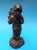 A Japanese bronzed figure of a peasant lady, 19.