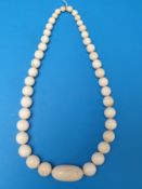 An 19thC/20thC ivory bead necklace, the central bead oblong,