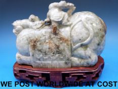 A Chinese jadeite carved model of an old man and a boy on an elephant,