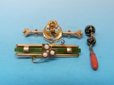 A yellow metal brooch set with a long rectangular strip of jade and four pearls arranged in a