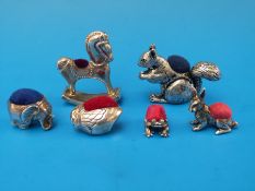 Four silver pin cushions including rocking horse, rabbit,