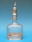 A continental white metal mounted etched glass decanter of rectangular form with chamfered corners,