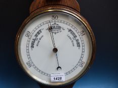 An early 20th century aneroid oak banjo barometer