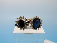 Two hallmarked 9ct gold rings each set with a central sapphire surrounded by diamonds (size K)