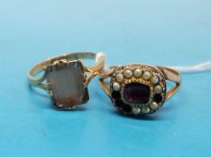 A yellow metal Georgian ring marked 9ct gold set with a garnet  to the centre surrounded by seed