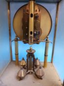 An anniversary clock mounted in glass case together with a similar example