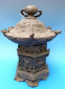 A Chinese bronze lantern/ censer with open work scenes of mythical creatures against clouds in the