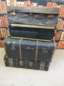 A collection of vintage luggage including a travelling robe