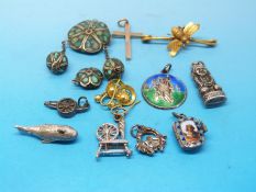 A collection of white metal / silver charms to include a whale, St Christopher,