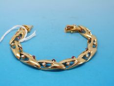 An 18ct gold bracelet, the stylized S-shaped links set with diamonds and rubies (34.