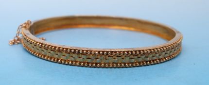 A late 19thC / 20thC yellow metal bracelet with relief decoration in original case for F T Depree,