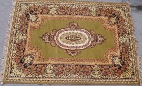 A large rug with floral design on a green ground (L295 x W201cm)