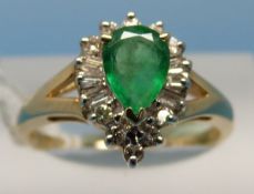 A yellow metal ring marked 14k set with a teardrop shaped emerald surrounded by diamonds (size N)