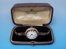 A ladies' 9ct gold watch with an enamel face