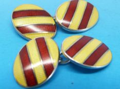 A pair of hallmarked silver and guilloché enamel cufflinks in red and yellow diagonal stripes
