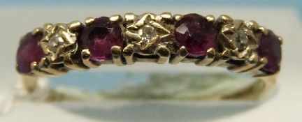 A 9ct gold ring set with alternating rubies and diamonds (size L)