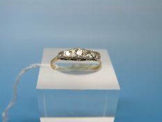 An 18ct gold ring set with five diamonds in a platinum setting (size M)