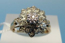 A 9ct gold ring set with diamonds in a cluster (size N)