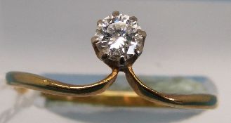 An 18ct gold ring set with a diamond of approximately 0.