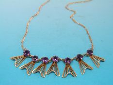 A 9ct gold necklace with suspended fan shaped decoration,