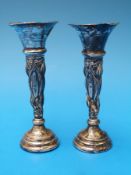 A pair of hallmarked silver repoussé decorated trumpet vases,