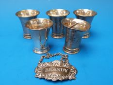 Five white metal shot measures,