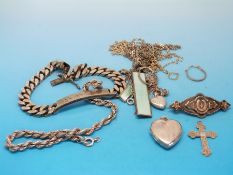 A collection of silver jewellery to include a silver locket, hallmarked silver identity bracelet,