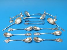 Three hallmarked silver sifter spoons including a Georgian example, a hallmarked silver caddy spoon,