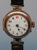 A 9ct gold cased wristwatch, indistinctly marked to dial, in J.