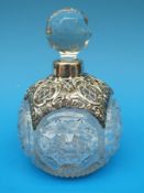 A cut glass scent bottle with a hallmarked silver pierced and embossed collar (Birmingham 1907)