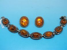 A silver and amber bracelet with matching earrings
