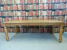 A pine kitchen table with planked top,