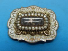 A 19thC mourning brooch with an oval compartment of plaited hair to the centre initialled J N in