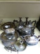 A quantity of silver plated items to include candlesticks, tea sets, basket,