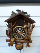 Two Black Forest cuckoo clocks, both with wooden reeds and cuckoo,