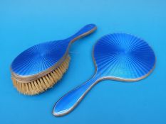 A hallmarked silver and blue guilloché enamel hand mirror and brush