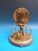 A Kundo anniversary clock mounted on four curved feet